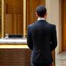 Professional concierge assisting a resident at a reception desk